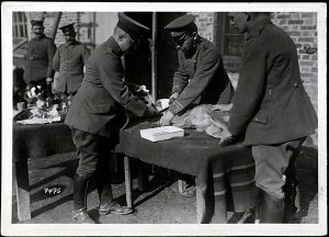 Binding the head of a messenger dog wounded by shrapnel