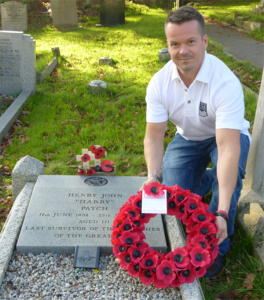 Neil White, Web Manager for Forces War Records, lays a wreath on the grave 