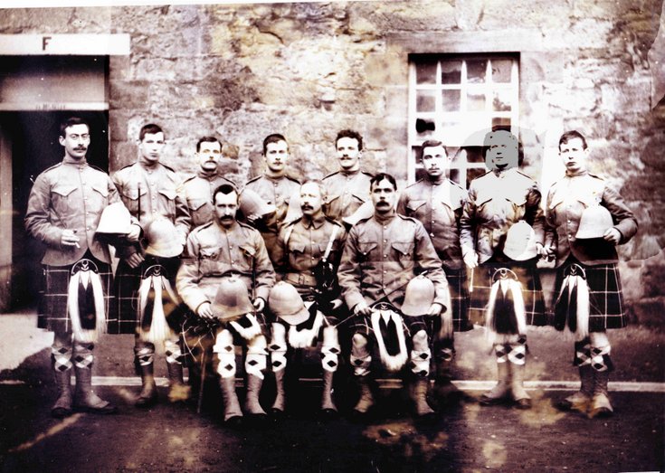 The image shows a group of 11 soldiers of the Seaforth Highlanders, in uniform, at Fort George, Inverness, Scotland, in 1900. The recruits are wearing kilts and holding their foreign service helmets. Alexander is in the front row, on the right. © Kindly provided by Forces War Records community member Rosie L.