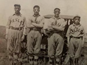 Cecil Minary (left) with his brothers, Victor, Bruce and Arnott. All avid baseball players. The photo was taken in a field in front of a motor vehicle. They are all wearing baseball uniforms. Image provided by Kendra Minary for the Letters from my ancestor blog. 