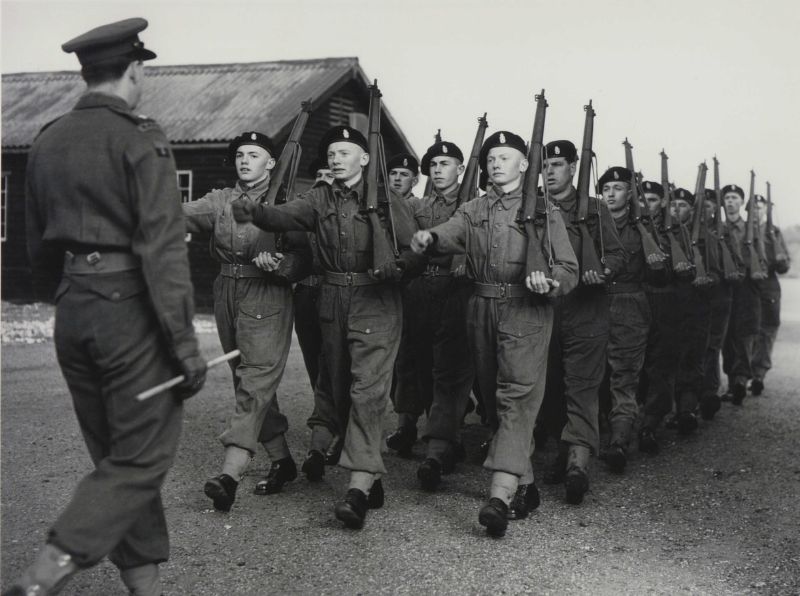 British Army National Service conscripts being drilled at North Frith Barracks. The image shows recruits in lines of three marching in uniform, arms shouldered. In this blog, we provide some top tips on how to find National Service records. © Hulton Archive/Getty Images