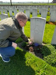 Matt visiting the grave of his great uncle Walter. The sun is shining, and Matt places a small bunch of flowers on the grave. Rows of white headstones are seen in the background. We've used a number of records to research Matt's ANZAC ancestor's military service during WWI. Image provided by Matt W.