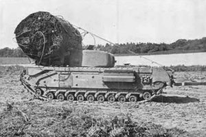 An AVRE, like the one L/Sgt. Scaife operated during the Normandy landings. This AVRE is carrying a large roll of chestnut palings in a bundle on top to form a causeway in ditches for tanks to pass across. Publisher: Messrs Hutchinson & Co.