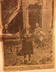 Cutting from an unnamed newspaper showing Dora and her mother in front of their bombed-out house. Dora musters a smile for the camera, and both women are holding possessions in their arms. It is believed that Dora met John Merritt Wentworth after her house was destroyed in the Blitz. Image provided by Jo E. 